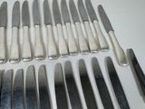 a lot of knives that are sitting on a table