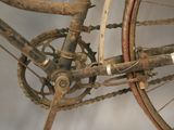 a dirty bike with a chain attached to it