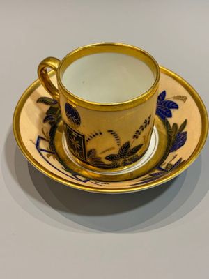 a cup and saucer sitting on a table