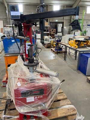 a picture of a machine in a warehouse with pallets of wood