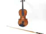 a violin that is sitting next to a bow