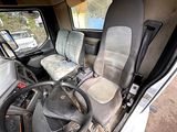 a truck with a steering wheel and a seat in the back