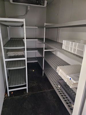 a small room with shelves and shelves in it