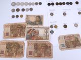 several different types of currency are displayed on a table