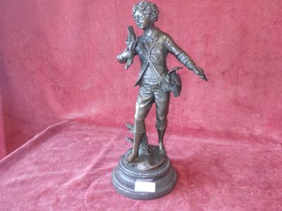 bronze statue of a man holding a dog on a pedestal