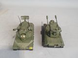 two toy tanks sitting next to each other on a table