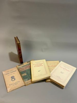 several books are stacked on top of each other on a table