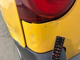 a measuring tape on the back of a yellow car