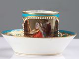 a cup and saucer with a picture of a man and a woman on it