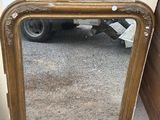 a mirror that is sitting on the ground next to a wall