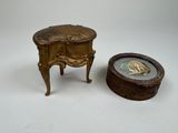 a small table and a small box on a white surface