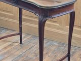 a small table with a glass top sitting on a wooden floor