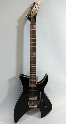 an electric guitar sitting on top of a white surface
