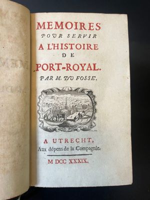 an open book with a picture of a town on it