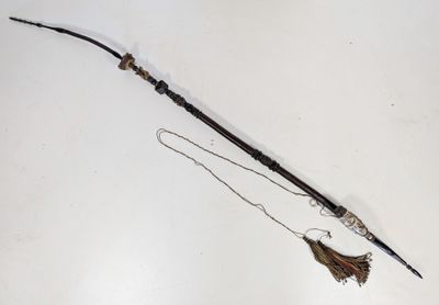 a long stick with a tassel attached to it