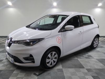 a picture of a white car that is parked in a garage