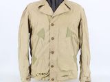 the jacket is tan and has a green design on it