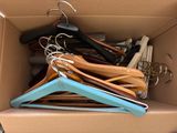 a cardboard box with a bunch of hangers in it