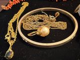 a picture of a necklace, bracelet, and ring on a table