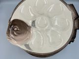 a fish shaped bowl sitting on top of a white table