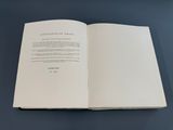 an open book sitting on top of a table next to a blue table