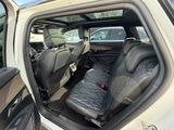 the back seats of a car with the door open and the driver ' s seat in the back