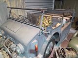 an old car that is being worked on in the garage