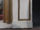 a cat that is sitting on the floor in front of a door