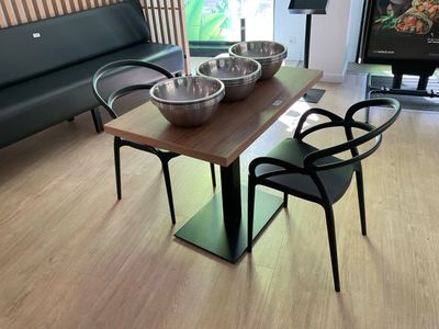 a table with two bowls of food on it in a living room