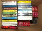 a lot of cassettes in a box on the floor
