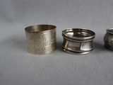 three silver napkin rings sitting next to each other on a table