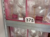 a lot of wine glasses on the shelves in the store