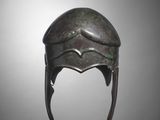 a bronze helmet with horns on a gray background