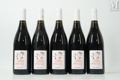 six bottles of wine are lined up on a table