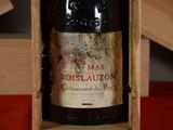 a bottle of wine in a wooden box on a table