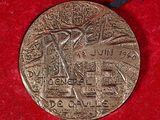 an old silver medal on a red cloth with a ribbon around it