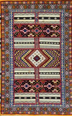 a multicolored rug with a geometric design on it