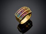 a gold ring with multi colored stones on a black surface