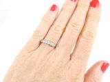 an image of a woman ' s hand with a diamond ring on it
