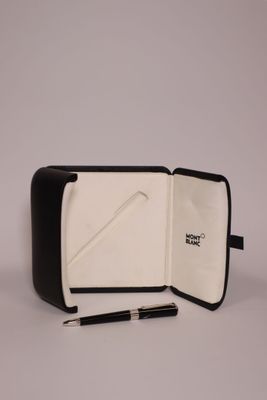 black and white case with a pen inside of it on a white surface