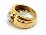 yellow gold ring with a single diamond on top of it