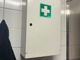 a green sign on the wall of a public restroom