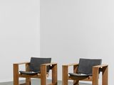 deux fauteuils en cuir noir dans une pièce blanche aux murs blancs