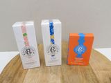 three boxes of soap sitting on top of a wooden table