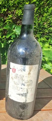 two bottles of wine sitting on a wooden table