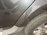 a close up of a car ' s front bumper and fender