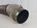 a metal exhaust pipe that is on a table