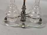 two glass vases sitting on top of a glass stand