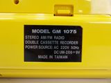 a close up of a yellow radio that is on a table