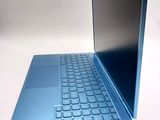 a laptop with a blue keyboard sitting on a white surface